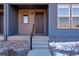 Inviting front entrance featuring a stylish door with house number and a well-maintained walkway at 16777 W 94Th Way, Arvada, CO 80007