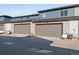 Attached two-car garage with gray doors and modern exterior finishes on a sunny day at 16777 W 94Th Way, Arvada, CO 80007
