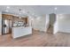 Open concept kitchen with stainless appliances, center island, and staircase to the upper level at 16777 W 94Th Way, Arvada, CO 80007