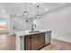 This kitchen island features stainless steel dishwasher, brown cabinets, a white countertop, and an undermount sink at 16777 W 94Th Way, Arvada, CO 80007