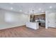 Modern kitchen with stainless steel appliances and marble backsplash open to a spacious living area at 16777 W 94Th Way, Arvada, CO 80007