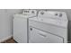 Clean, organized laundry room featuring a white, front-loading washer and dryer set at 16777 W 94Th Way, Arvada, CO 80007