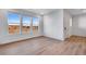 Bright living room featuring three large windows providing stunning views and natural light at 16777 W 94Th Way, Arvada, CO 80007