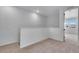 Small loft area with neutral carpet and paint leading to bright bedrooms with lots of light at 16777 W 94Th Way, Arvada, CO 80007