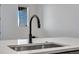 This undermount sink features stainless steel hardware, composite countertop, and a modern, black faucet at 16777 W 94Th Way, Arvada, CO 80007