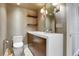 Stylish powder room with a modern vanity, designer mirror, elegant lighting, and unique wall coverings at 3131 E Alameda Ave # 1302, Denver, CO 80209