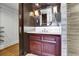 Cozy powder room features a wood vanity, illuminated mirror, and a stylish design at 3131 E Alameda Ave # 1302, Denver, CO 80209