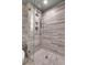 A modern bathroom featuring sleek gray textured tiling and a glass-enclosed shower at 3131 E Alameda Ave # 1302, Denver, CO 80209