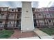 Three-story condo building with multiple balconies and manicured landscaping, showing curb appeal at 8645 Clay St # 400, Westminster, CO 80031