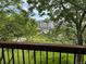 Exterior view from the balcony overlooking a grassy area with trees and a distant building complex at 8645 Clay St # 400, Westminster, CO 80031