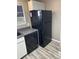 Features a black refrigerator, dishwasher, granite countertop, and light wood-style laminate flooring at 8645 Clay St # 400, Westminster, CO 80031