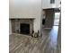 Inviting living room featuring a stone fireplace, wood-style flooring, and access to the outdoor balcony at 8645 Clay St # 400, Westminster, CO 80031