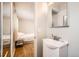 Bathroom with a sink and a view into a bedroom with a double bed at 14937 E Security Way, Aurora, CO 80011