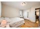 Calm bedroom featuring hardwood floors, white walls, and a closet with mirrored sliding doors at 14937 E Security Way, Aurora, CO 80011