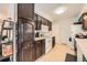 Well-equipped kitchen with dark wood cabinets, modern appliances, and ample storage space at 14937 E Security Way, Aurora, CO 80011