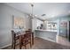 Charming dining space adjacent to the kitchen with modern light fixture at 9431 Ashbury Cir # 103, Parker, CO 80134