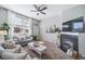 Bright living room featuring a fireplace, ceiling fan, and nice decor at 9431 Ashbury Cir # 103, Parker, CO 80134