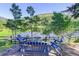 A tranquil outdoor seating area with a wooden fence offers stunning views of the lake at 4241 S Meadow Brook Ln, Evergreen, CO 80439