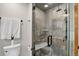 Modern walk-in shower with tile surround, glass door, and rain showerhead at 4241 S Meadow Brook Ln, Evergreen, CO 80439