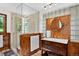 Bathroom with glass shower, wood paneling, and traditional-style sink at 4241 S Meadow Brook Ln, Evergreen, CO 80439