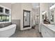 Bathroom featuring a soaking tub, dual sinks, and a decorative mirror at 4241 S Meadow Brook Ln, Evergreen, CO 80439