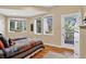 Bedroom with two beds, hardwood floors, large windows, and sliding door access to a deck at 4241 S Meadow Brook Ln, Evergreen, CO 80439