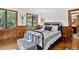 Bedroom with wood accents, natural light, and a cozy atmosphere at 4241 S Meadow Brook Ln, Evergreen, CO 80439