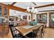 Dining area with wood beams, views to the outdoors, and comfortable furnishings at 4241 S Meadow Brook Ln, Evergreen, CO 80439