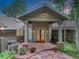 Inviting front entrance with a stone walkway, decorative plants, and wood accents at 4241 S Meadow Brook Ln, Evergreen, CO 80439