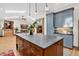Open kitchen featuring an island with seating and dark countertops, and high-end stainless steel appliances at 4241 S Meadow Brook Ln, Evergreen, CO 80439
