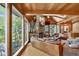 Living room with wood ceiling, a stone fireplace, and large windows at 4241 S Meadow Brook Ln, Evergreen, CO 80439