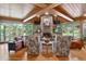Living room with stone fireplace, vaulted wood ceiling, and views of the property at 4241 S Meadow Brook Ln, Evergreen, CO 80439