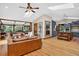 Open concept living room and kitchen with hardwood floors and multiple skylights at 4241 S Meadow Brook Ln, Evergreen, CO 80439