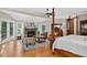 Open main bedroom layout showcasing a seating area, fireplace, hardwood floors, and natural light at 4241 S Meadow Brook Ln, Evergreen, CO 80439