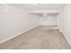 An open basement space with carpet flooring and built-in shelving, great for storage at 1856 S Monroe St, Denver, CO 80210