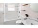 Bright bathroom featuring tiled shower and bath, with modern fixtures and finishes at 1856 S Monroe St, Denver, CO 80210