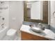 A modern bathroom features a unique bowl sink, decorative mirror, and marble countertops at 1856 S Monroe St, Denver, CO 80210