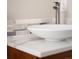 Close up of bathroom featuring modern bowl sink, chrome faucet, decorative backsplash, and hardwood cabinet at 1856 S Monroe St, Denver, CO 80210