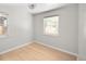 Bright bedroom features hardwood floors, natural light from windows, and a modern ceiling light fixture at 1856 S Monroe St, Denver, CO 80210
