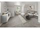Stylishly staged bedroom boasts neutral colors, comfortable seating, and a calming atmosphere at 1856 S Monroe St, Denver, CO 80210
