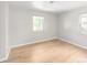 Bright bedroom featuring hardwood floors and natural lighting through two windows at 1856 S Monroe St, Denver, CO 80210