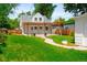 Charming home featuring a pergola-covered patio, lush lawn, and a neatly landscaped yard providing inviting curb appeal at 1856 S Monroe St, Denver, CO 80210