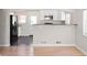Open-concept kitchen featuring white cabinetry, granite countertops, and stainless steel appliances at 1856 S Monroe St, Denver, CO 80210