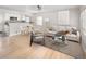 Bright, open-concept living area features hardwood floors and flows seamlessly into the kitchen at 1856 S Monroe St, Denver, CO 80210