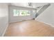 Well-lit living room showcases hardwood floors, staircase, and a large window, providing an airy feel at 1856 S Monroe St, Denver, CO 80210