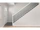 Staircase featuring hardwood steps and black metal railings at 1856 S Monroe St, Denver, CO 80210