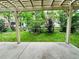 Backyard showcasing lush lawn and mature trees, visible from the shaded patio at 6102 S Yampa St, Aurora, CO 80016