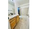 Bathroom features a vanity with stone countertop, tub with tile surround and a shower curtain at 6102 S Yampa St, Aurora, CO 80016