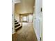 Welcoming front entryway with carpet flooring, stairs to the left, and a bright living room at 6102 S Yampa St, Aurora, CO 80016