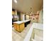 Open kitchen with tile floors, a large marble center island, and stainless steel appliances at 6102 S Yampa St, Aurora, CO 80016